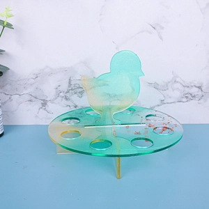 Macro detail of a green glitter chicken resin storage rack with multiple storage holes