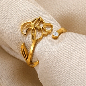 Macro shot of gold adjustable ring featuring hollow floral design and sparkling zircon
