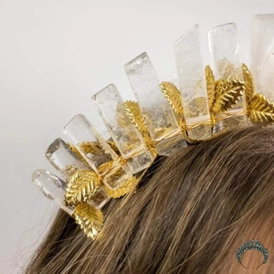 Detail of handmade crown headband featuring golden metal leaves and purple amethyst crystal