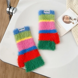 Detail of colorful rainbow striped plush fingerless gloves with soft knit texture