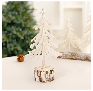 Close-up of a mini white snow-covered Christmas tree with a rustic natural wood base
