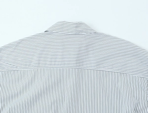 Close-up of the back yoke seam showing precision striped poplin shirt tailoring details