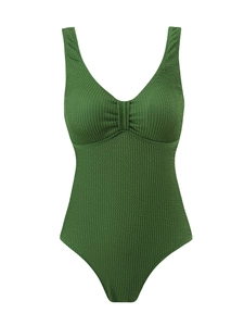 Gros plan du tissu côtelé vert foncé sur un maillot de bain une pièce à col en V