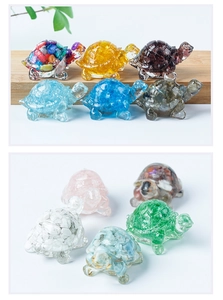Close-up of small carved turtle figurines made from various natural crystal gemstones