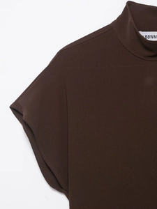 Close-up of the elegant high-neckline and shoulder stitching of a dark brown sleeveless top