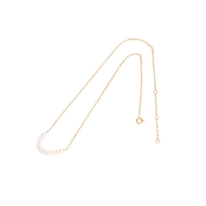 Elegant gold chain necklace featuring freshwater pearls in a delicate curved arrangement