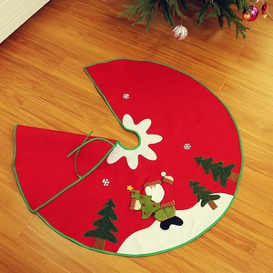 Detail of red Christmas tree skirt with snowman and tree embroidery on wood floor