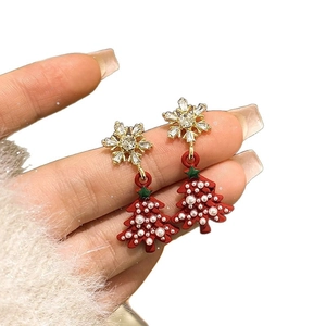 Elegant snowflake and Christmas tree earrings with pearls and rhinestones on white background