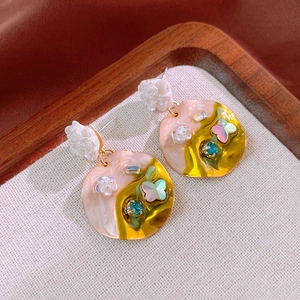 Close-up of floral butterfly crystal drop earrings with artistic oil painting enamel style