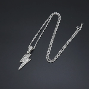 Close-up of silver lightning bolt pendant with clear crystals on a classic rope chain