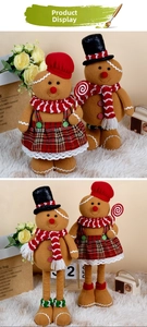 Detail of plush gingerbread chef couple with candy canes for Christmas decor