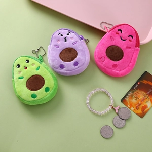 Close-up of cute plush avocado coin purses in green, purple, and pink with metal chains