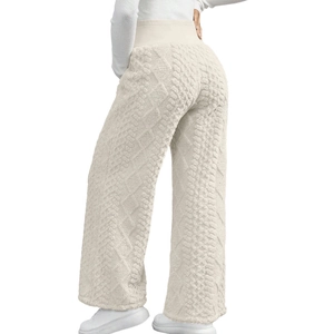 Close-up of cream knit maternity pants featuring thick cable stitch texture and high waist