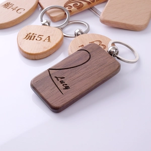 Custom engraved walnut wood keychain with name Lucy and zodiac signs motifs