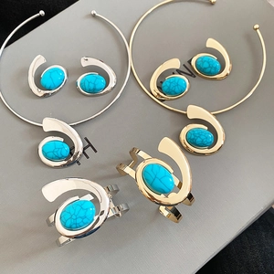 Golden and silver jewelry sets with turquoise stones and spiral geometric design elements