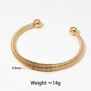 Détail d'un bracelet ressort doré de 6,8mm avec embouts boules et finition polie
