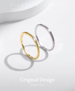 Detail of gold and silver hammered metal rings featuring rectangular cubic zirconia