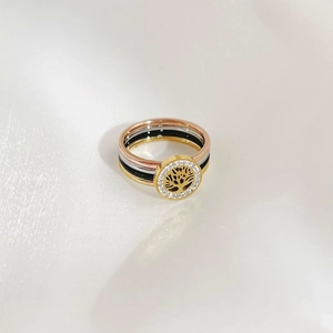 Detailed top view of layered Tree of Life rings with zircon pavé on silk fabric