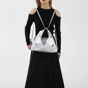 Silver retro shoulder bag with butterfly charm and smooth leather texture on model