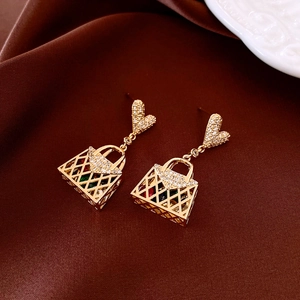 Detailed view of heart-shaped studs and mesh handbag pendants with colorful gems