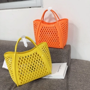 Detail showing two colorful hollow-out PVC tote baskets in yellow and orange tones