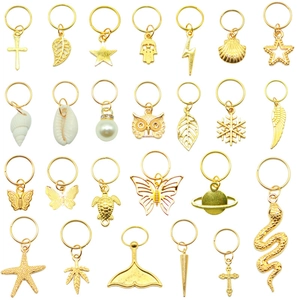 24-piece golden hair ring set featuring assorted charms like stars, shells and butterflies