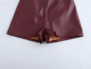 Detail of wine red PU leather shorts showing inner lining and fine stitching craftsmanship