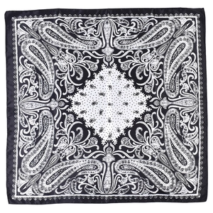Detailed macro view of black and white paisley pattern on soft satin square scarf
