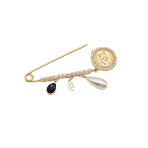 Baroque gold brooch with pearls, coin pendant, and black gemstone on white background