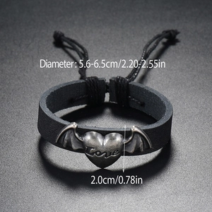 Detail of adjustable black woven leather bracelet with winged love heart metal charm