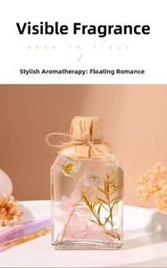 Detail of square glass reed diffuser with dried hydrangea and daisies in oil