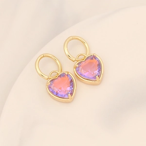 Detail of 18K gold earrings featuring heart-cut purple and pink gradient crystals