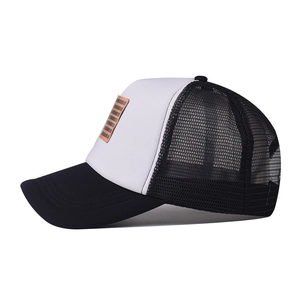 Side view of black and white trucker hat with breathable mesh and stripe patch