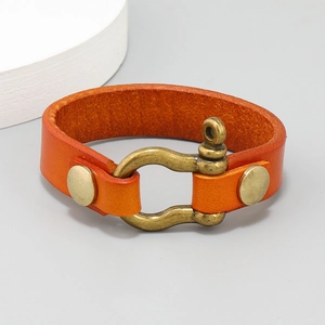 Close-up of orange cowhide leather bracelet featuring a bronze horseshoe U-shackle clasp