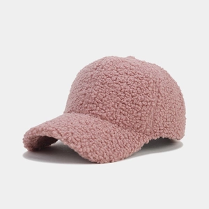 Close-up of pink thickened lamb wool baseball cap with soft granular fleece texture