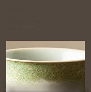 Macro shot of smooth polished ceramic tea cup rim with vintage crystalline glaze