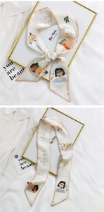 Detail of silk scarf with artistic female portrait and floral design for hair styling