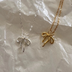 Elegant 925 silver bow pendant necklace available in gold and silver finishes on white paper