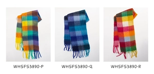 Three colorful plaid scarves with tassels in yellow, blue and red patterns