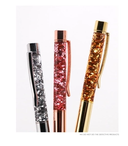 Close-up of glitter pens in gold, rose gold and silver with sparkling sand filling