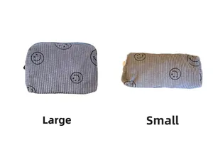 Detailed comparison of grey corduroy makeup bags in large and small sizes with smiley prints