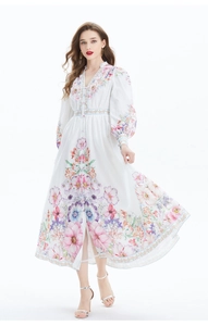 Detailed view of floral print and V-neckline button closure on the white linen dress