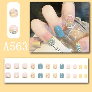 Detailed set of floral and polka dot press-on nails with blue and pink pastel tones