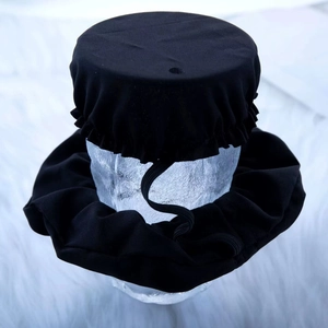 Detail of black elastic anti-spiking drink cover set placed on a glass display head