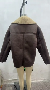 Back view of brown shearling jacket featuring plush cream collar and vertical stitching