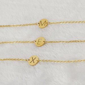 Three 18K gold plated stainless steel initial bracelets with M, E, X pendants