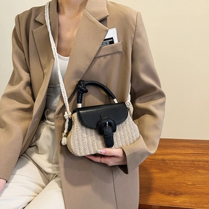 Minimalist straw woven crossbody handbag featuring black leather trim and woven rope strap