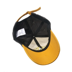 Detail view of cotton baseball cap interior with contrast stitching and metal buckle