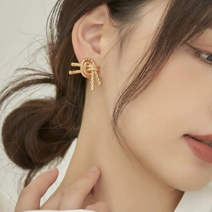 Elegant gold knot stud earrings for women in durable stainless steel with spiral texture