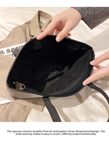 Internal view of black tote bag showing spacious compartment with inner zipper pocket